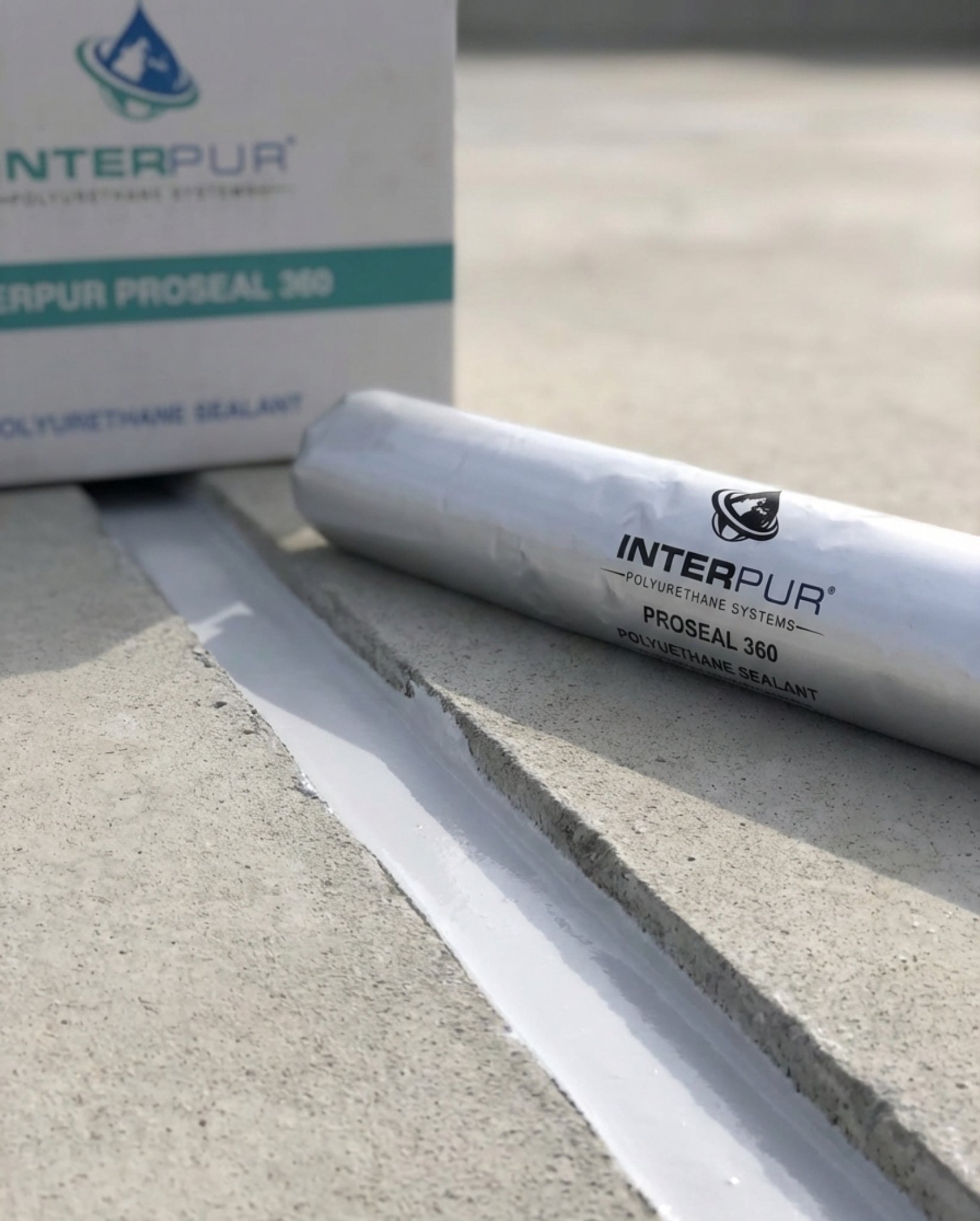 Technician applying sealant around a building window frame